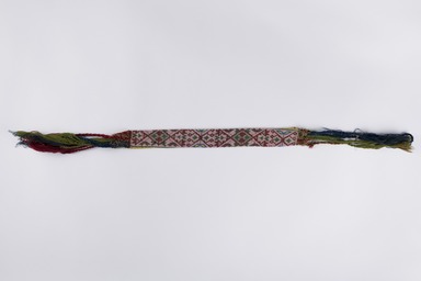 Menominee. <em>Beadwork Strip with blue, red and green wool twisted fringe</em>, 1900s. Beads, wool, 38 x 1 3/4 in.  (96.5 x 4.4 cm). Brooklyn Museum, Gift of Samuel E. Haslett, 28800. Creative Commons-BY (Photo: Brooklyn Museum, 28800_overall_PS22.jpg)