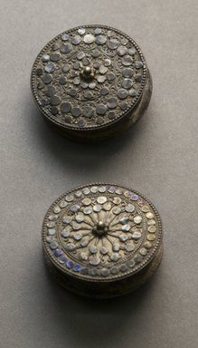 Swahili /Bajun. <em>Pair of Earrings</em>, early 20th century. Silver, inlaid, 1/2 x 1 11/16 in. (1.2 x 4.3 cm). Brooklyn Museum, Gift of Lucy Addoms, 30.1254a-b. Creative Commons-BY (Photo: Brooklyn Museum, 30.1254a-b_front_PS10.jpg)