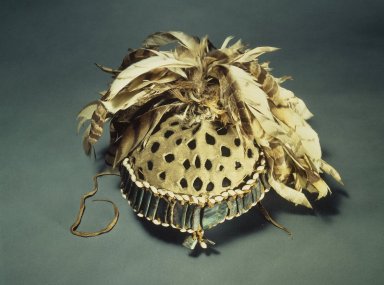 A:shiwi (Zuni Pueblo). <em>Bow Priest's Cap</em>, 1880s. Hide, feathers, shells, plant fiber cord, cotton string, sinew, 5 3/4 x 11 in. (14.6 x 27.9 cm). Brooklyn Museum, Estate of Stewart Culin, Museum Purchase, 30.797. Creative Commons-BY (Photo: Brooklyn Museum, 30.797.jpg)