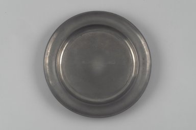 Shelton & Feltman (American, active 1847). <em>Dish or Paten</em>, ca. 1847. Pewter, 1 x 10 1/4 x 10 1/4 in. (2.5 x 26 x 26 cm). Brooklyn Museum, Gift of Theodora Wilbour, 32.2089. Creative Commons-BY (Photo: Brooklyn Museum, 32.2089.jpg)