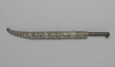  <em>Dagger and Sheath</em>, 1827. Iron alloy (steel) and copper alloy with gilding; sheath: copper alloy, chased and repoussé decoration, and wood lining
, Length of Knife: 16 in. (40.6 cm). Brooklyn Museum, Gift of the executors of the Estate of Colonel Michael Friedsam, 32.769a-b. Creative Commons-BY (Photo: Brooklyn Museum, 32.769_closed_PS2.jpg)