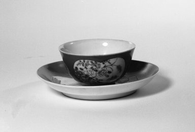  <em>Cup and Saucer</em>, 1723-1735. Porcelain with famillie rose overglaze and red ground, A: 1 3/4 x 3 1/4 in. (4.5 x 8.3 cm). Brooklyn Museum, Gift of the executors of the Estate of Colonel Michael Friedsam, 32.969a-b. Creative Commons-BY (Photo: Brooklyn Museum, 32.969a-b_bw.jpg)
