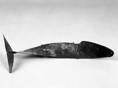 Alaska Native. <em>Game Piece Shaped Like Whale</em>, 1900-1930. Wood, 14 1/2 x 6 1/2 x 2 1/2 in. or (36.5 x 6.0 cm). Brooklyn Museum, Gift of Frank K. Fairchild, 36.71. Creative Commons-BY (Photo: Brooklyn Museum, 36.71_bw.jpg)