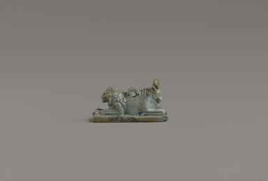  <em>Lion and Bull Amulet</em>, 664-332 B.C.E. Faience, height: 9/16 in. (1.4 cm). Brooklyn Museum, Charles Edwin Wilbour Fund, 37.1246E. Creative Commons-BY (Photo: Brooklyn Museum, 37.1246E_profile1_PS9.jpg)
