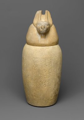  <em>Canopic Jar and Lid (Depicting a Jackal)</em>, 664–404 B.C.E. Limestone, 11 9/16 (29.3 cm) high x 5 1/4 in. (13.4 cm) diameter. Brooklyn Museum, Charles Edwin Wilbour Fund, 37.894Ea-b. Creative Commons-BY (Photo: Brooklyn Museum, 37.894Ea-b_front_PS1.jpg)