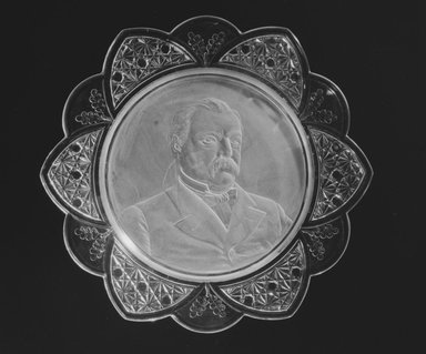  <em>Plate (Grover Cleveland)</em>, ca. 1884. Glass, 1 1/8 x 11 1/2 x 11 1/2 in. (2.9 x 29.2 x 29.2 cm). Brooklyn Museum, Gift of Mrs. William Greig Walker by subscription, 40.163. Creative Commons-BY (Photo: Brooklyn Museum, 40.163_bw.jpg)