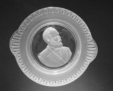 <em>Plate (James Garfield)</em>, ca. 1881. Glass, 1 1/2 x 10 x 9 in. (3.8 x 25.4 x 22.9 cm). Brooklyn Museum, Gift of Mrs. William Greig Walker by subscription, 40.169. Creative Commons-BY (Photo: Brooklyn Museum, 40.169_bw.jpg)