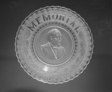  <em>Plate (James Garfield)</em>, ca. 1881. Glass, 1 1/4 x 10 x 10 in. (3.2 x 25.4 x 25.4 cm). Brooklyn Museum, Gift of Mrs. William Greig Walker by subscription, 40.172. Creative Commons-BY (Photo: Brooklyn Museum, 40.172_bw.jpg)