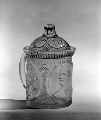  <em>Mug with Lid (William McKinley)</em>, ca. 1896. Glass, Overall: 5 x 4 x 3 3/8 in. (12.7 x 10.2 x 8.6 cm). Brooklyn Museum, Gift of Mrs. William Greig Walker by subscription, 40.175a-b. Creative Commons-BY (Photo: Brooklyn Museum, 40.175_bw.jpg)