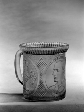  <em>Mug</em>, ca. 1896. Glass, 3 5/8 x 4 x 3 3/8 in. (9.2 x 10.2 x 8.6 cm). Brooklyn Museum, Gift of Mrs. William Greig Walker by subscription, 40.176. Creative Commons-BY (Photo: Brooklyn Museum, 40.176_bw.jpg)