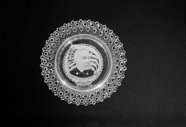  <em>Plate (George Dewey)</em>, ca. 1899. Glass, 3/4 x 5 1/2 x 5 1/2 in. (1.9 x 14 x 14 cm). Brooklyn Museum, Gift of Mrs. William Greig Walker by subscription, 40.185. Creative Commons-BY (Photo: Brooklyn Museum, 40.185_bw.jpg)