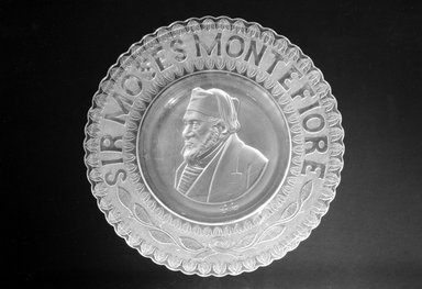  <em>Plate (Sir Moses Montefiore)</em>, ca. 1885. Glass, 1 1/4 x 10 1/2 x 10 1/2 in. (3.2 x 26.7 x 26.7 cm). Brooklyn Museum, Gift of Mrs. William Greig Walker by subscription, 40.193. Creative Commons-BY (Photo: Brooklyn Museum, 40.193_bw.jpg)