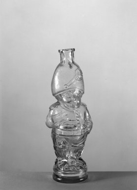 American. <em>Bottle, Figure of Napoleon Bonaparte</em>, late 19th century. Glass, 7 1/4 x 2 x 2 in. (18.4 x 5.1 x 5.1 cm). Brooklyn Museum, Gift of Mrs. William Greig Walker by subscription, 40.277. Creative Commons-BY (Photo: Brooklyn Museum, 40.277_acetate_bw.jpg)