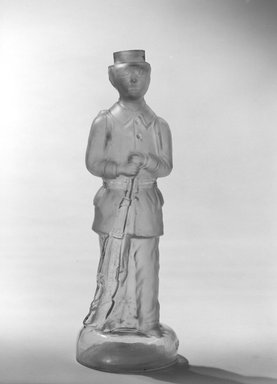 American. <em>Bottle, Figure of French Soldier</em>, late 19th century. Glass, 11 1/2 x 3 3/4 x 3 3/4 in. (29.2 x 9.5 x 9.5 cm). Brooklyn Museum, Gift of Mrs. William Greig Walker by subscription, 40.280. Creative Commons-BY (Photo: Brooklyn Museum, 40.280_bw.jpg)