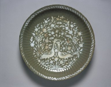  <em>Platter (Tabaq) Depicting Cranes</em>, first half of the 17th century. Ceramic; fritware, painted in white slip under a grayish-celadon glaze, 17 15/16 x 3 1/8 in. (45.5 x 8 cm). Brooklyn Museum, Gift of Mrs. Horace O. Havemeyer, 42.212.39. Creative Commons-BY (Photo: Brooklyn Museum, 42.212.39_SL1.jpg)