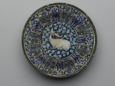  <em>Dish with a Seated Deer</em>, late 13th to 14th century. Ceramic, Sultanabad ware; fritware, painted in black, blue, and turquoise under a transparent glaze, 1 15/16 x 7 9/16 in. (5 x 19.2 cm). Brooklyn Museum, Gift of Mrs. Horace O. Havemeyer, 42.212.9. Creative Commons-BY (Photo: Brooklyn Museum, 42.212.9_top_PS2.jpg)