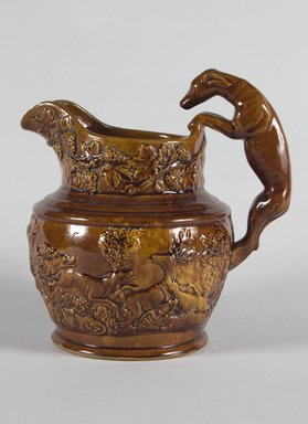 Harker Taylor & Co.. <em>Pitcher, Hound Handle</em>, ca. 1847. Rockingham glaze, 8 3/4 in. (22.2 cm). Brooklyn Museum, Gift of Arthur W. Clement, 43.128.40. Creative Commons-BY (Photo: Brooklyn Museum, 43.128.40_PS5.jpg)
