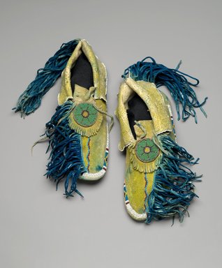 Kiowa. <em>Pair of Moccasins</em>, mid-20th century. Hide, beads, pigments, 10 1/4 x 3 13/16 in.  (26 x 9.7 cm). Brooklyn Museum, Gift of the Estate of Ida Jacobus Grant, 44.116.11a-b. Creative Commons-BY (Photo: Brooklyn Museum, 44.116.11a-b_PS2.jpg)