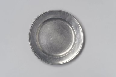 Jehiel Johnson. <em>Plate</em>, 1815–1825. Pewter, 5/8 x 7 15/16 x 7 15/16 in. (1.6 x 20.2 x 20.2 cm). Brooklyn Museum, Gift of Arthur W. Clement, 45.1.5. Creative Commons-BY (Photo: Brooklyn Museum, 45.1.5.jpg)