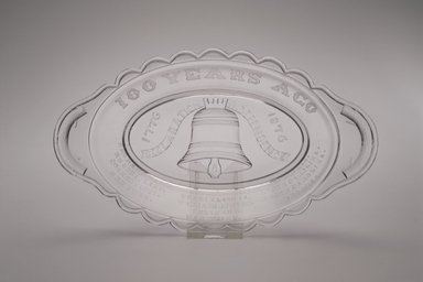 American. <em>Pickle Dish (Centennial)</em>, ca. 1876. Glass, 1 3/8 x 9 3/8 x 5 3/8 in. (3.5 x 23.8 x 13.7 cm). Brooklyn Museum, Anonymous gift, 46.161.2. Creative Commons-BY (Photo: Brooklyn Museum, 46.161.2_Justin_van_Soest_photograph.jpg)