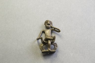 Akan. <em>Gold-weight (abrammuo): seated figure</em>. Brass, 1 15/16 x 1 1/4 x 11/16 in. (5 x 3.2 x 1.7 cm). Brooklyn Museum, Charles Stewart Smith Memorial Fund, 46.95.3. Creative Commons-BY (Photo: Brooklyn Museum, 46.95.3_PS5.jpg)