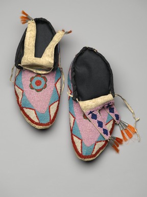Blackfoot. <em>Pair of Men's Moccasins</em>, late 19th-early 20th century. Leather, beads, orange horse hair, tin, Each: 10 1/4 x 4 3/4 in. (26 x 12.1 cm). Brooklyn Museum, Charles Stewart Smith Memorial Fund, 46.96.9a-b. Creative Commons-BY (Photo: Brooklyn Museum, 46.96.9a-b_view1_PS2.jpg)
