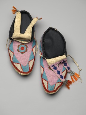 Blackfoot. <em>Pair of Men's Moccasins</em>, late 19th–early 20th century. Leather, beads, orange horse hair, tin, Each: 10 1/4 x 4 3/4 in. (26 x 12.1 cm). Brooklyn Museum, Charles Stewart Smith Memorial Fund, 46.96.9a-b. Creative Commons-BY (Photo: Brooklyn Museum, 46.96.9a-b_view1_PS2.jpg)