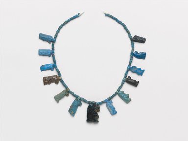  <em>Single-Strand Necklace with Taweret Amulets</em>, ca. 1332–1292 B.C.E. Faience, 3/4 x 8 1/16 x 3/16 in. (1.9 x 20.5 x 0.4 cm). Brooklyn Museum, Gift of Mrs. Lawrence Coolidge and Mrs. Robert Woods Bliss, and the Charles Edwin Wilbour Fund, 48.66.42. Creative Commons-BY (Photo: Brooklyn Museum, 48.66.42_PS2.jpg)