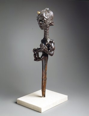 Lulua. <em>Figure of a Mother Holding a Child  (Lupingu lwa Cibola)</em>, 19th century. Wood, copper alloy, palm oil, tukula, organic materials, 14 x 3 3/8 x 3 1/2 in. (35.6 x 8.6 x 8.9 cm). Brooklyn Museum, Museum Collection Fund, 50.124. Creative Commons-BY (Photo: Brooklyn Museum, 50.124_view2_SL4.jpg)