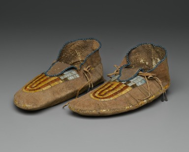 Sioux. <em>Pair of Moccasins</em>, early 19th century. Hide, beads, bird quills, porcupine quills, tin, deer hair, sinew, pigment, 4 x 5 x 11 in. (10.2 x 12.7 x 27.9 cm). Brooklyn Museum, Henry L. Batterman Fund and Frank Sherman Benson Fund, 50.67.23a-b. Creative Commons-BY (Photo: Brooklyn Museum, 50.67.23a-b_three_quarter_PS2.jpg)
