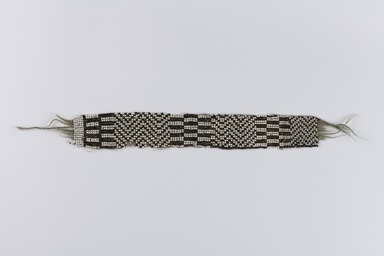 Chippewa (Anishinaabe). <em>Garter</em>, early 19th century. Yarn, garnet beads, pony beads, 11 3/4 x 1 11/16 in. (29.8 x 4.3 cm). Brooklyn Museum, Henry L. Batterman Fund and the Frank Sherman Benson Fund, 50.67.37a. Creative Commons-BY (Photo: Brooklyn Museum, 50.67.37a_overall_PS22.jpg)