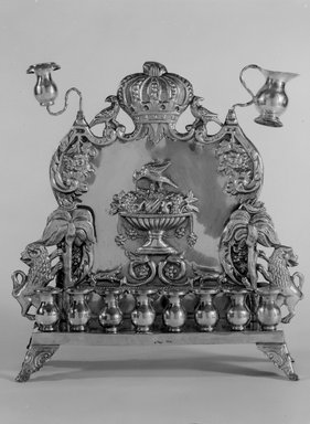 B. Szkarlad. <em>Hanukkah Lamp</em>, ca. 1900. Silver, 10 3/4 x 10 1/8 x 3 1/4 in. (27.3 x 25.7 x 8.3 cm). Brooklyn Museum, Gift of Mrs. William Linder in memory of Dr. William Linder, 50.7. Creative Commons-BY (Photo: Brooklyn Museum, 50.7_bw.jpg)