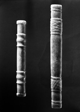 Chorotegan. <em>A Long Cylindrical Ceremonial Bar Pendant</em>. Jadeite, 7/8 x 7 9/16 in. (2.3 x 19.2 cm). Brooklyn Museum, Gift of Alastair Bradley Martin, 53.248a. Creative Commons-BY (Photo: , 53.248a_53.248b_group_bw.jpg)