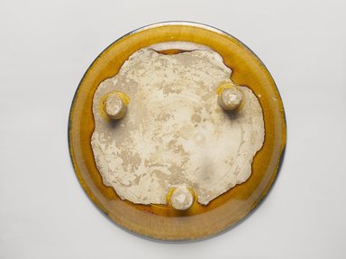  <em>Tripod Plate</em>, 618–907. Earthenware, 3 color (sancai) lead glaze, 2 3/8 x 11 3/4 in. (6 x 29.9 cm). Brooklyn Museum, William E. Hutchins Collection, 53.90. Creative Commons-BY (Photo: Brooklyn Museum, 53.90_back_PS9.jpg)