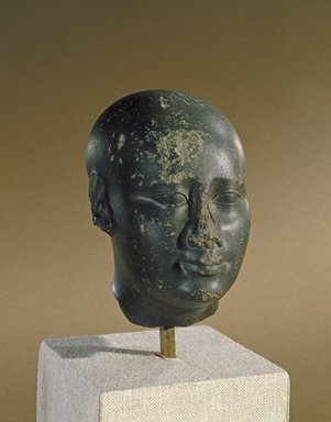  <em>Idealized Head</em>, ca. 300 B.C.E. Basalt, 4 13/16 x 3 1/16 x 4 1/2 in. (12.3 x 7.7 x 11.5 cm). Brooklyn Museum, Charles Edwin Wilbour Fund, 55.178. Creative Commons-BY (Photo: Brooklyn Museum, 55.178_SL1.jpg)