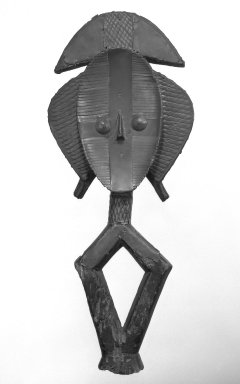Kota (Ndumu or Obamba subgroup). <em>Reliquary Figure (Mbulu Ngulu)</em>, late 19th-early 20th century. Wood, copper alloy, copper, accumulated/applied materials, 20 3/4 x 8 3/8 x 2 1/4 in. (52.7 x 21.3 x 5.9 cm). Brooklyn Museum, Gift of Arturo and Paul Peralta-Ramos, 56.6.19. Creative Commons-BY (Photo: Brooklyn Museum, 56.6.19_bw.jpg)