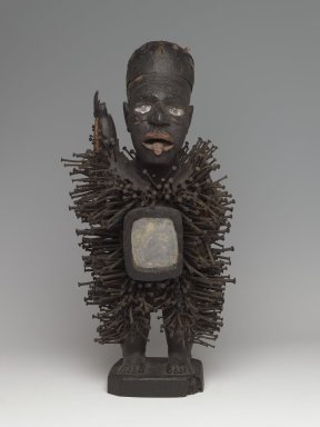 Kongo (Solongo or Woyo subgroup). <em>Power Figure (Nkisi Nkondi)</em>, late 19th–early 20th century. Wood, iron, glass, fiber, pigment, bone, 24 x 6 1/2 x 8 1/2 in. (61.5 x 17.0 x 21.5 cm). Brooklyn Museum, Gift of Arturo and Paul Peralta-Ramos, 56.6.98. Creative Commons-BY (Photo: Brooklyn Museum, 56.6.98_front_PS6.jpg)