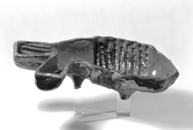  <em>Fish Mold</em>, 19th century. Glazed earthenware, 2 3/4 × 11 7/8 in. (7 × 30.2 cm). Brooklyn Museum, Gift of Huldah Cail Lorimer in memory of George Burford Lorimer, 57.75.31. Creative Commons-BY (Photo: Brooklyn Museum, 57.75.31_bw.jpg)