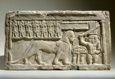  <em>Stela with Bes and Tutu</em>, 332–30 B.C.E. Limestone, 10 7/16 x 18 3/4 x 3 9/16 in., 47.4 lb. (26.5 x 47.7 x 9 cm, 21.5kg). Brooklyn Museum, Charles Edwin Wilbour Fund, 58.98. Creative Commons-BY (Photo: Brooklyn Museum, 58.98_SL1.jpg)