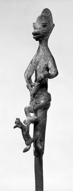 Yorùbá. <em>Ogboni Society Staff with Figure of Woman Nursing a Child (Ipawo Ase)</em>, late 19th or early 20th century. Copper alloy, iron, 9 1/16 x 14 in. (23.0 x 35.5 cm). Brooklyn Museum, Brooklyn Museum Collection, 61.246. Creative Commons-BY (Photo: Brooklyn Museum, 61.246_bw.jpg)