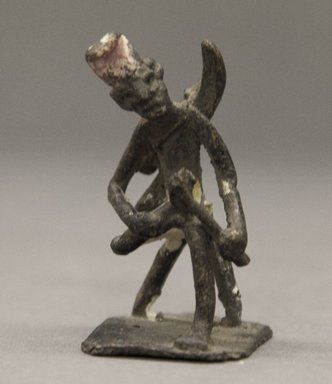 Fon. <em>Figure of Seated Male with Bow and Arrows</em>, late 19th or early 20th century. Copper alloy, height: (6.9 cm). Brooklyn Museum, Gift of Clara S. Peck, 64.212.1. Creative Commons-BY (Photo: Brooklyn Museum, 64.212.1_PS10.jpg)