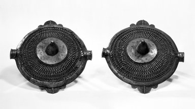 Asante. <em>One of pair of "Soul Washer's" Chest Ornaments</em>, late 19th or early 20th century. Copper alloy, 12 x 12 1/2 in. (30.5 x 31.8 cm). Brooklyn Museum, A. Augustus Healy Fund, 67.210.1. Creative Commons-BY (Photo: , 67.210.1_67.210.2_bw.jpg)