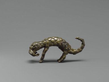 Akan. <em>Gold-weight (abrammuo): leopard</em>, 19th or 20th century. Brass, 1 11/16 x 3 3/4 in. (4.3 x 9.5 cm). Brooklyn Museum, Bequest of Laura L. Barnes, 67.25.14. Creative Commons-BY (Photo: Brooklyn Museum, 67.25.14_PS6.jpg)