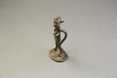 Akan. <em>Gold-weight (abrammuo): standing figure</em>. Brass, 2 13/16 x 1 5/16 x 1 in. (7.1 x 3.3 x 2.5 cm). Brooklyn Museum, Bequest of Laura L. Barnes, 67.25.3. Creative Commons-BY (Photo: Brooklyn Museum, 67.25.3_threequarter_PS5.jpg)