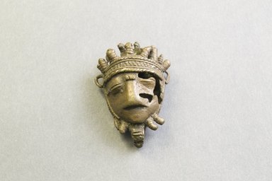 Akan. <em>Gold-weight (abrammuo): mask</em>. Brass, 2 3/16 x 1 9/16 x 13/16 in. (5.5 x 4 x 2 cm). Brooklyn Museum, Bequest of Laura L. Barnes, 67.25.7. Creative Commons-BY (Photo: Brooklyn Museum, 67.25.7_front_PS5.jpg)