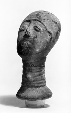 Akan. <em>Funerary Portrait Head</em>, late 19th or early 20th century. Buffware, reduced-fired, encrustation, wood, height: 6 3/8 in. (16.3 cm). Brooklyn Museum, Caroline A.L. Pratt Fund, 68.10.1. Creative Commons-BY (Photo: Brooklyn Museum, 68.10.1_threequarter_bw.jpg)