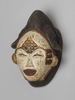 Punu. <em>Mask for the Okuyi Society (Mukudj)</em>, late 19th century. Wood, pigment, metal, 12 × 8 1/2 × 7 1/4 in. (30.5 × 21.6 × 18.4 cm). Brooklyn Museum, Gift of Mr. and Mrs. Milton Lowenthal through The Roebling Society, 68.160. Creative Commons-BY (Photo: Brooklyn Museum, 68.160_PS2.jpg)