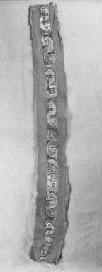Coastal Wari. <em>Mantle, Fragment or Border, Fragment</em>, 600-1000 C.E. Cotton, camelid fiber, 28 3/4 x 4 3/4in. (73 x 12cm). Brooklyn Museum, Gift of Ernest Erickson, 70.177.12. Creative Commons-BY (Photo: Brooklyn Museum, 70.177.12_cropped_bw_IMLS.jpg)