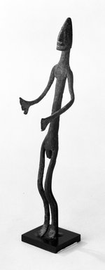 Dogon. <em>Staff with Standing Figure</em>, late 19th or early 20th century. Iron, 8 x 1 3/4 x 2 in. (20.4 x 4.5 x 5.1 cm). Brooklyn Museum, Gift of Elliot Picket, 70.72.3. Creative Commons-BY (Photo: Brooklyn Museum, 70.72.3_bw.jpg)