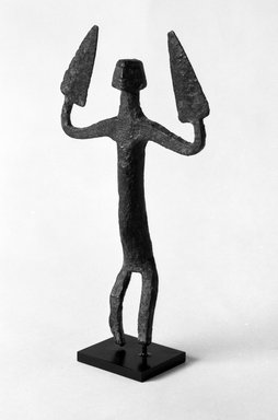 Dogon. <em>Standing Figure of a Nommo</em>, late 19th or early 20th century. Wrought iron, 8 x 4 1/4 x 1 in. (20.3 x 10.8 x 2.6 cm). Brooklyn Museum, Gift of Elliot Picket, 70.72.4. Creative Commons-BY (Photo: Brooklyn Museum, 70.72.4_bw.jpg)